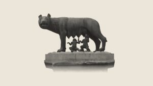 Bronze statue of the she-wolf nursing the infant twins Romulus and Remus, standing on a stone plinth.